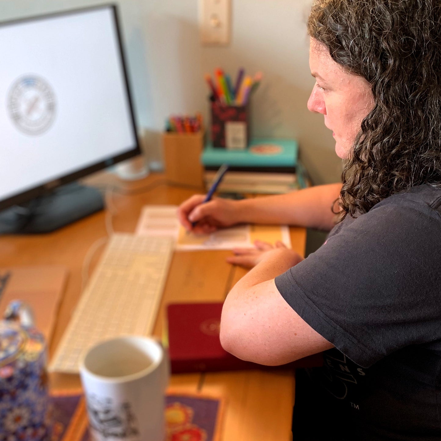 Gillian during a story consultation, taking notes of the client's story issues